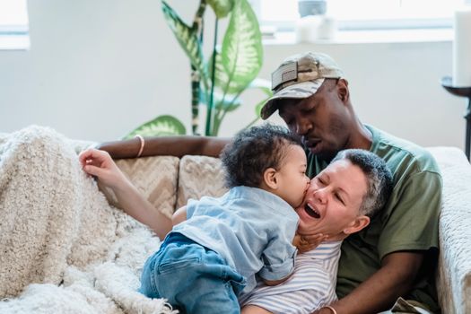 Family with Little Boy Lying on the Couch and Smiling 