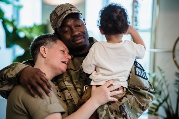 Soldier Hugging His Wife And Son 