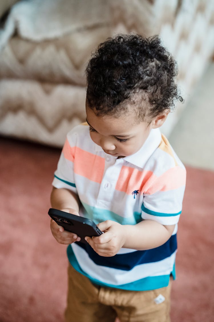 Toddler Playing A Game On A Phone