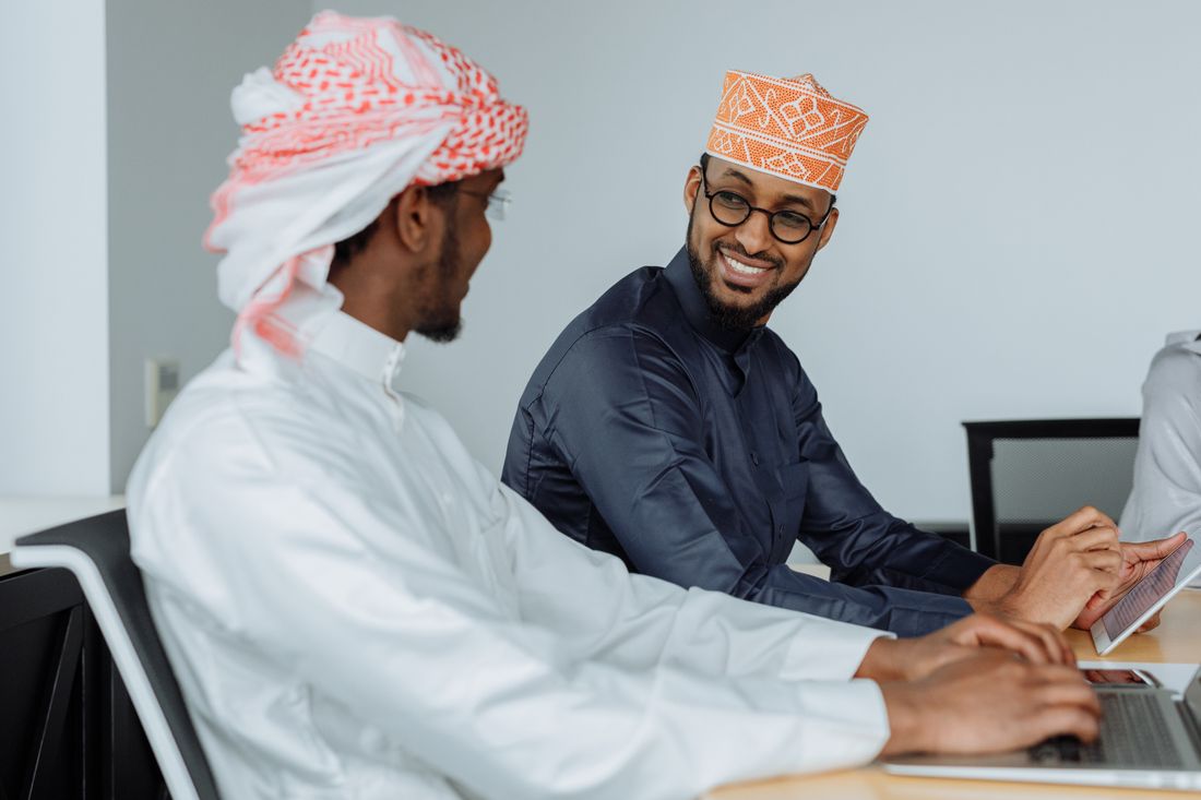 Vectribe team in the Gulf planning a client's monthly content calendar on laptops