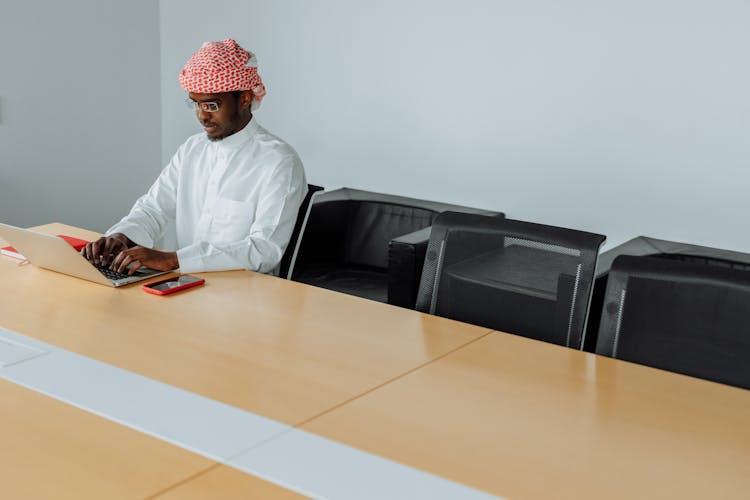 Man Typing On A Laptop