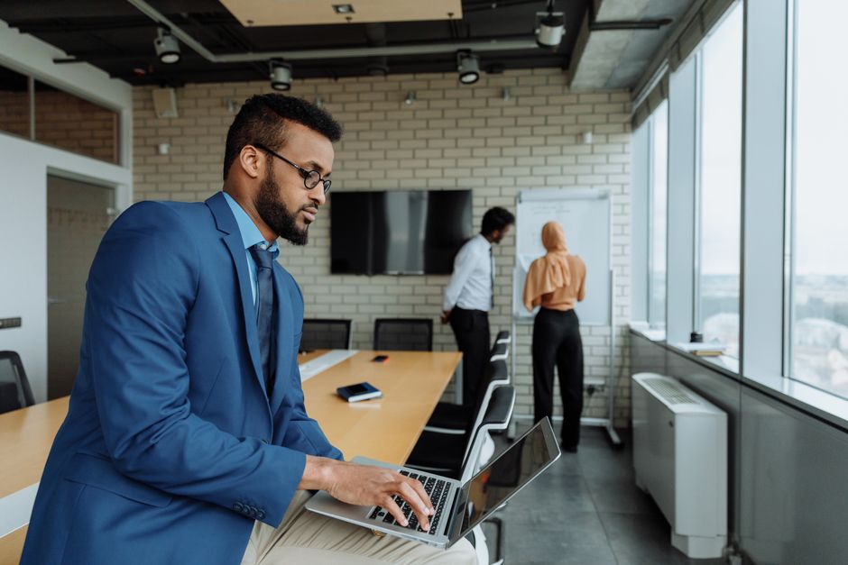 A professional team collaborating in a modern office setting, focusing on business strategies.