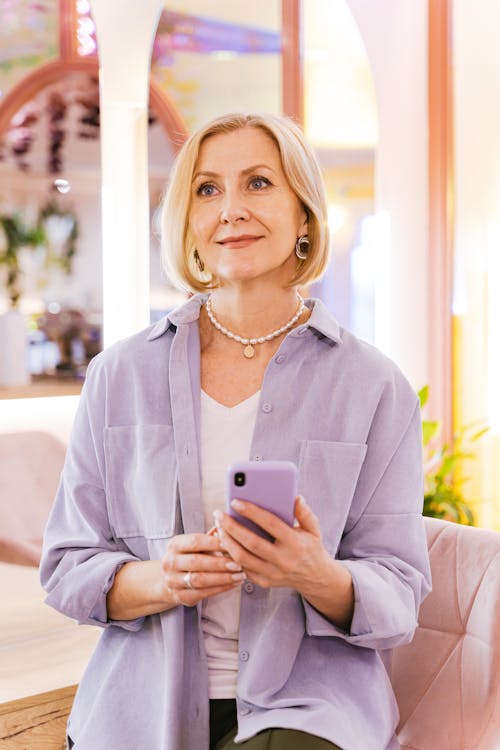 A Portrait of a Mature Woman Holding a Cellphone