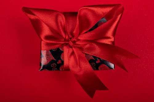 A Gift with a Red Ribbon and Heart Design Wrapping