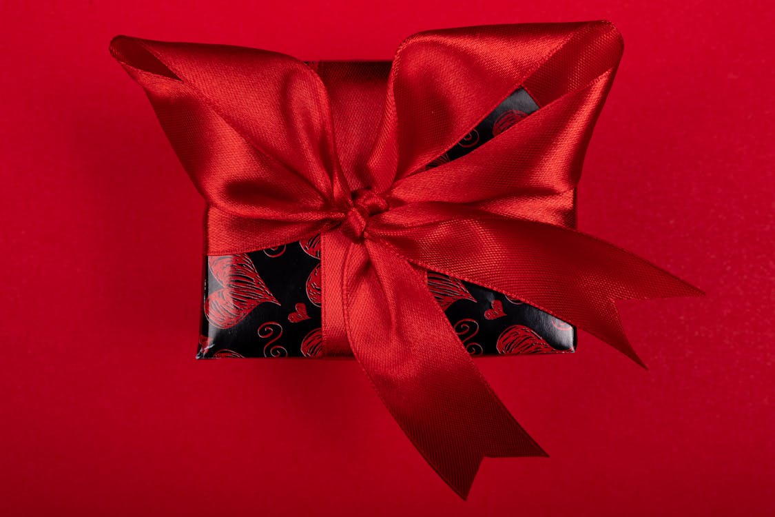 A Gift with a Red Ribbon and Heart Design Wrapping