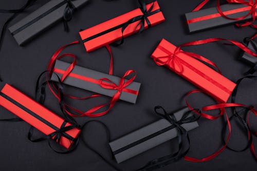 Black and Red Wrapped Gifts on the Table