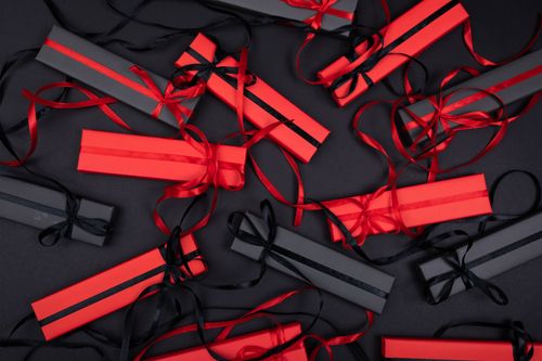 Free Top view of stylish black and red gift boxes with ribbons on a dark background, perfect for holiday celebrations. Stock Photo