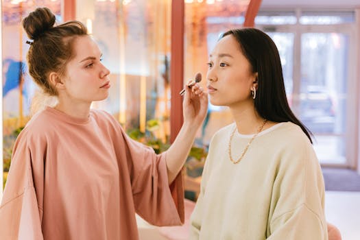 A makeup artist carefully applies makeup to a client in a beauty salon setting.