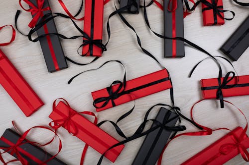 Red and Black Gift Boxes on the Wooden Surface
