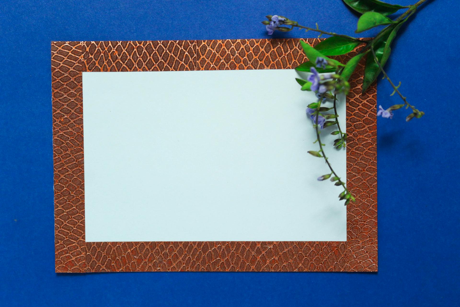 Blank Paper with Brown Border on Blue Background