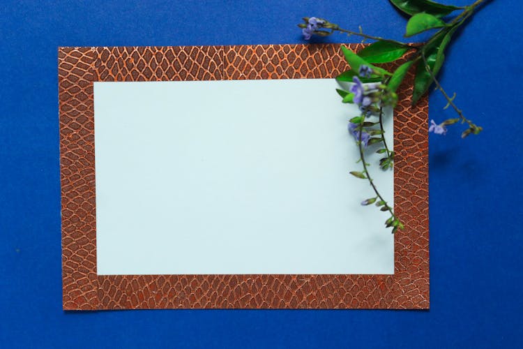 Blank Paper With Brown Border On Blue Background