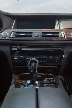 Explore the elegance of a luxury car interior highlighting a sleek dashboard and gear stick.