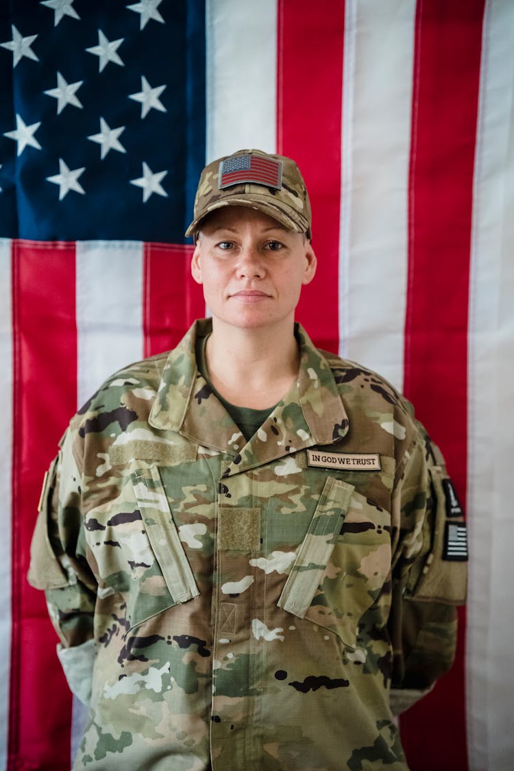 Woman Soldier In Uniform On American Flag Background