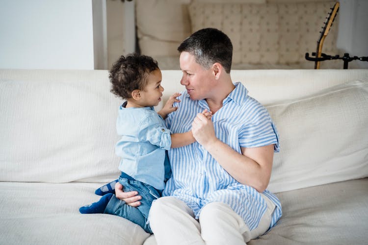 Mother And Son Talking And Hugging On A Sofa