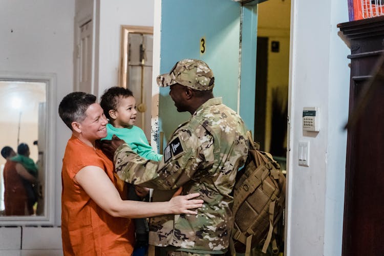 A Family Standing At The Doorway