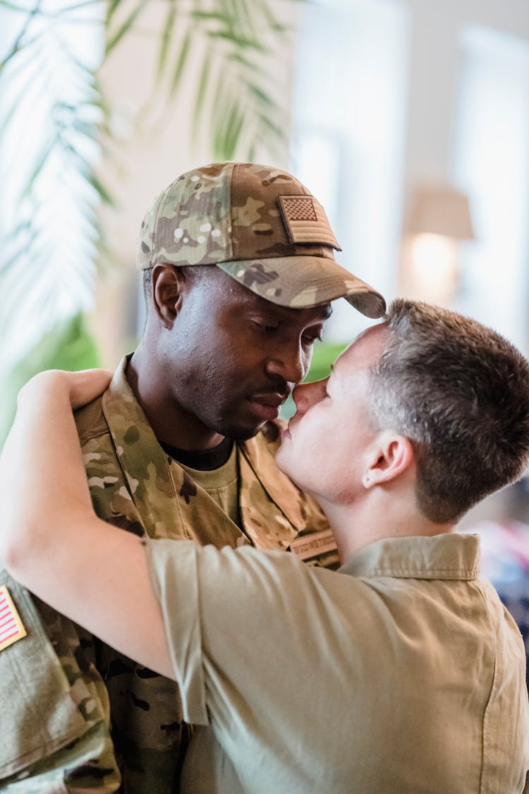 Man In Military Uniform Standing Face To Face With A Woman