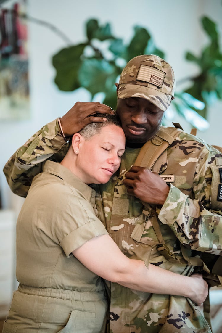 Woman Embracing The Man In Military Uniform 