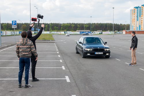 Camera Man Filming a Driver of Car in a Parking Lot