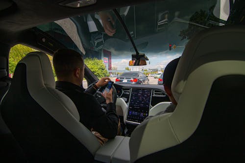 Free Man Driving a Tesla Stock Photo