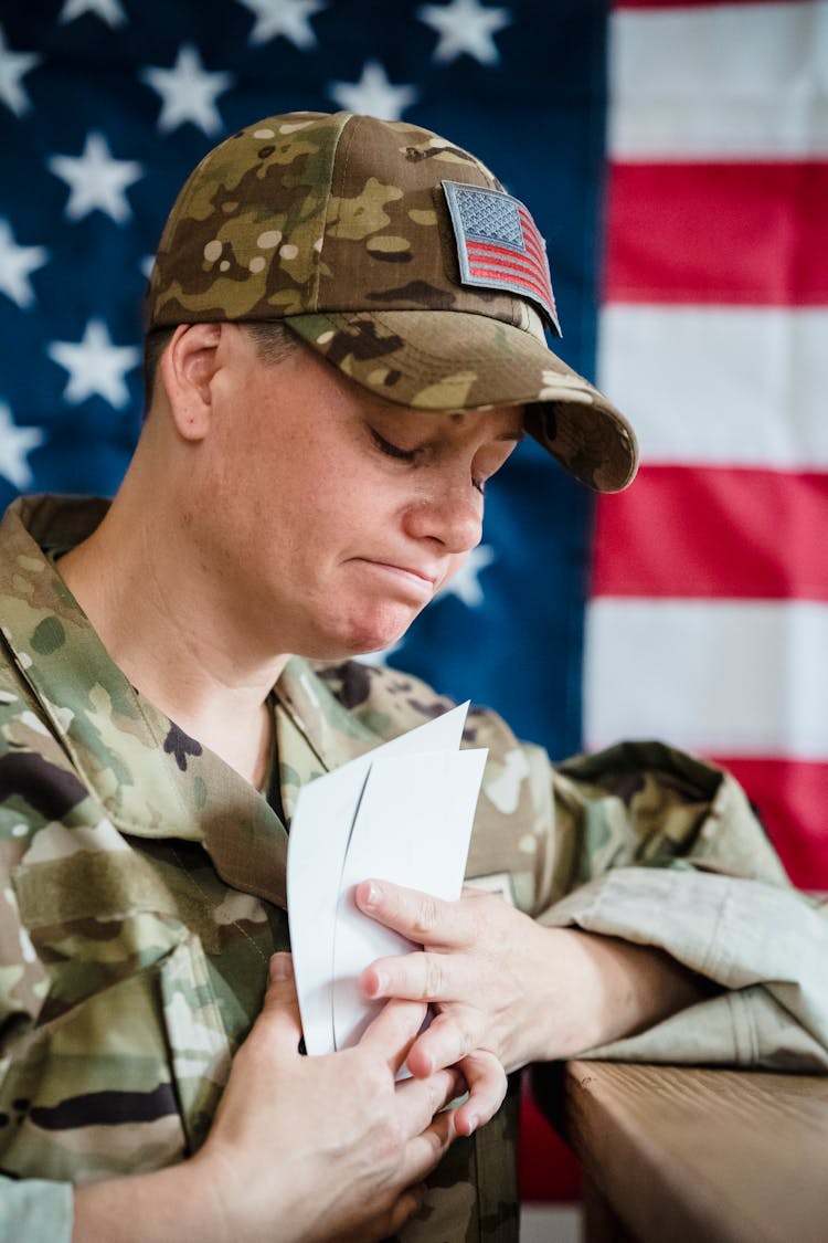 Woman In Military Uniform Holding White Paper Crying