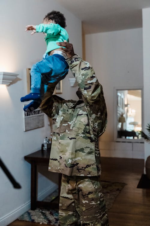 Free A Soldier Carrying a Child Stock Photo