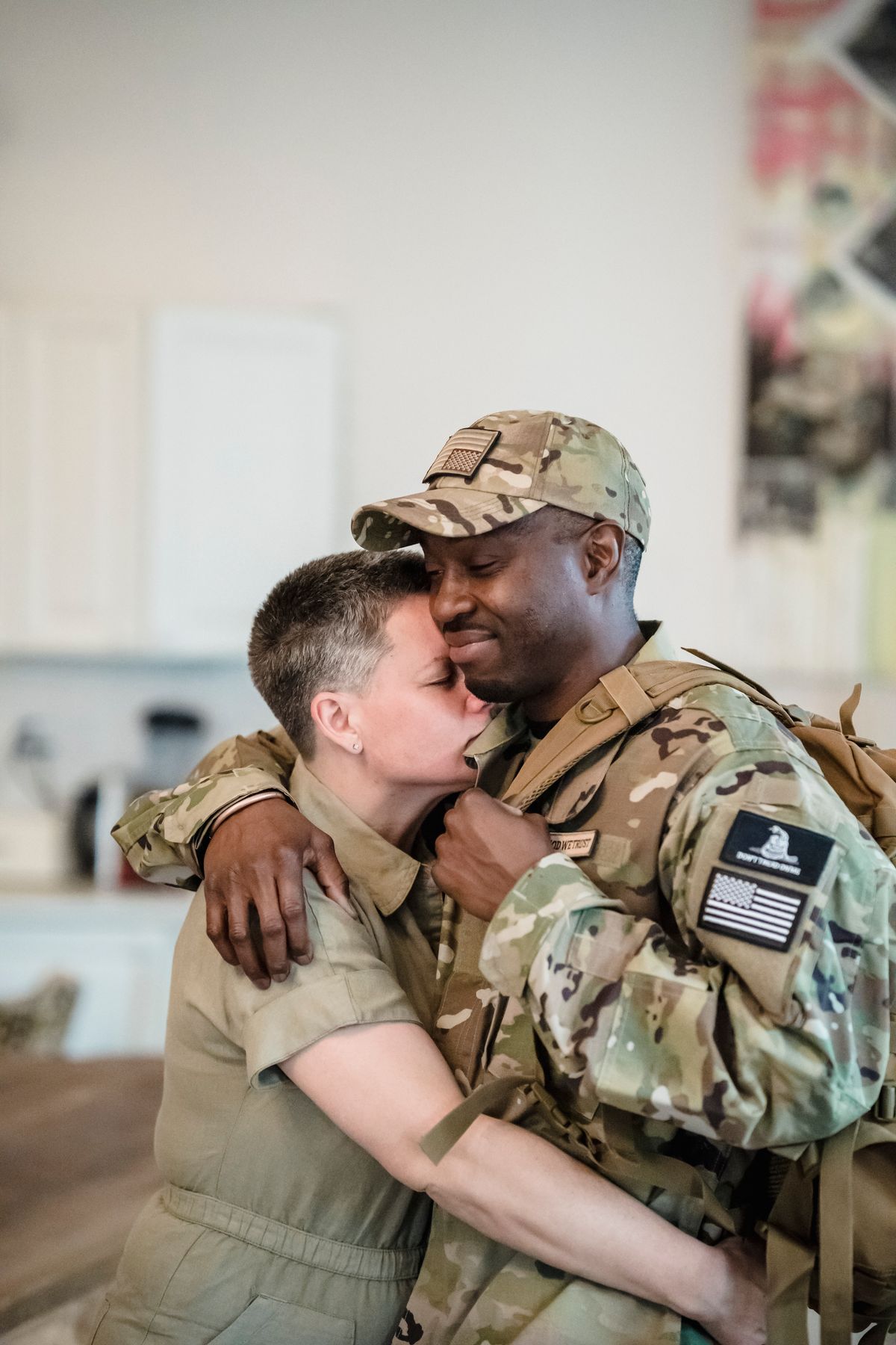 Military couple embracing, representing military family life and spouse benefits