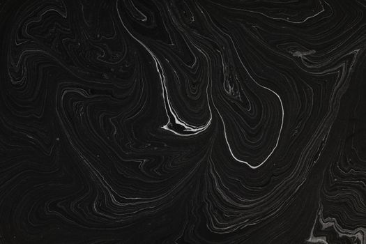 A dramatic black and white swirling pattern with artistic abstract design.