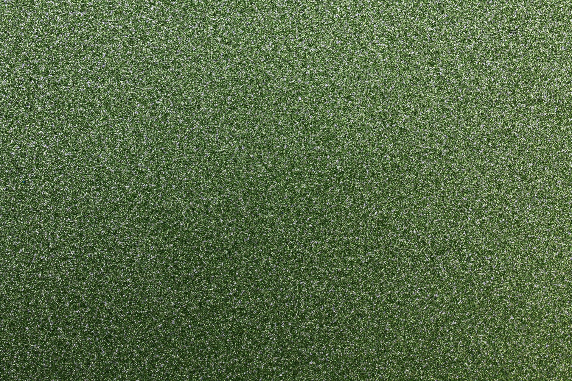 A close-up of a textured green fabric surface with a subtle pattern, perfect for backgrounds.