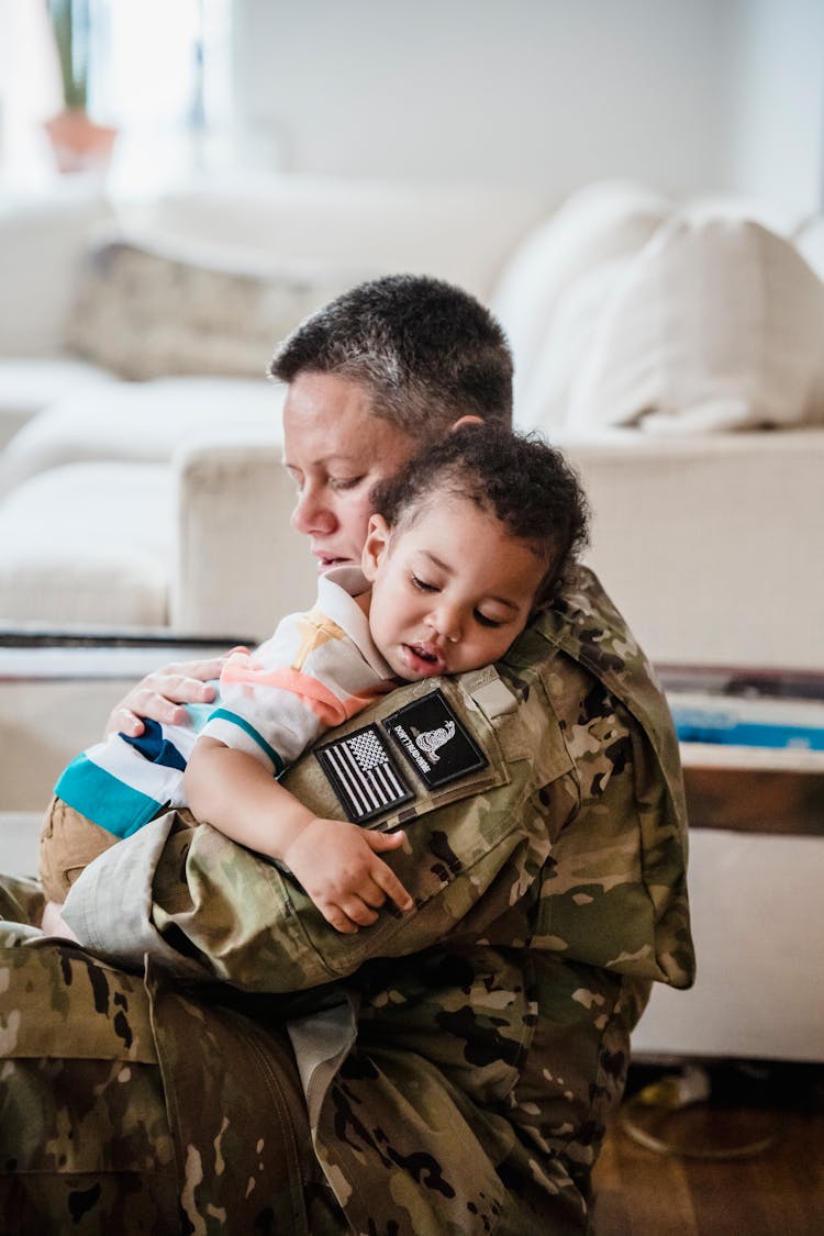 A Soldier Carrying A Child