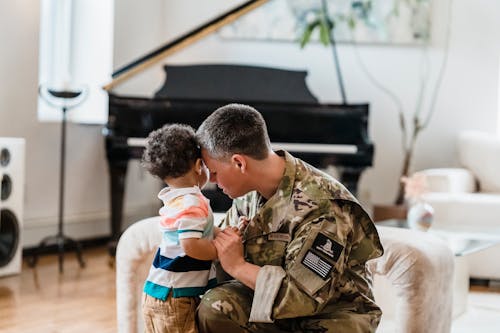 Free A Soldier Holding Hands with her Son Stock Photo