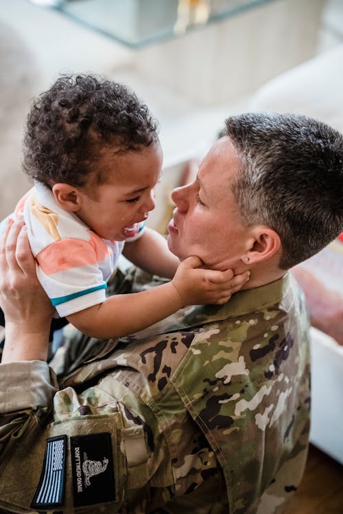 A Soldier Carrying her Crying Child