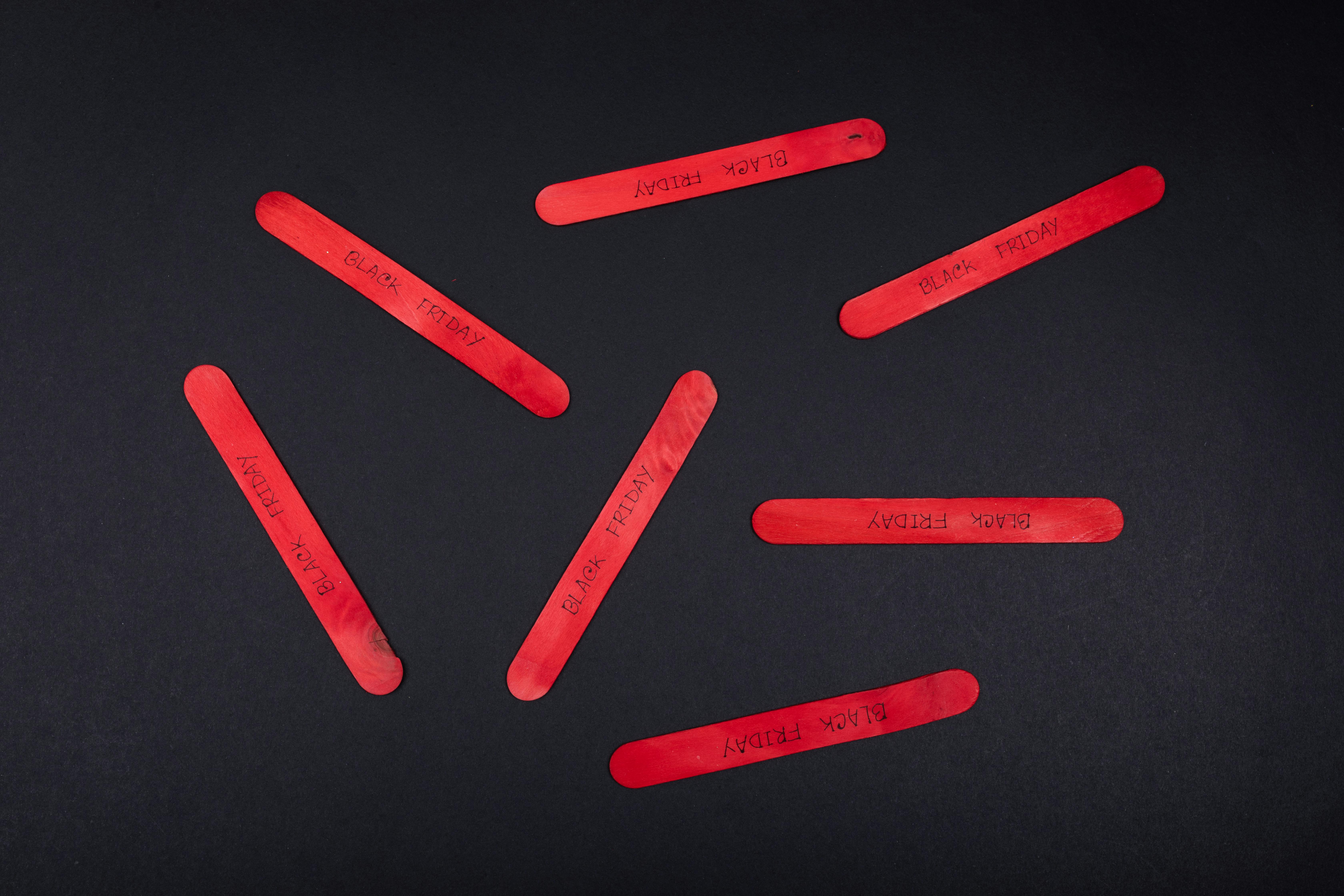Red Popsicle Sticks on Black Table · Free Stock Photo