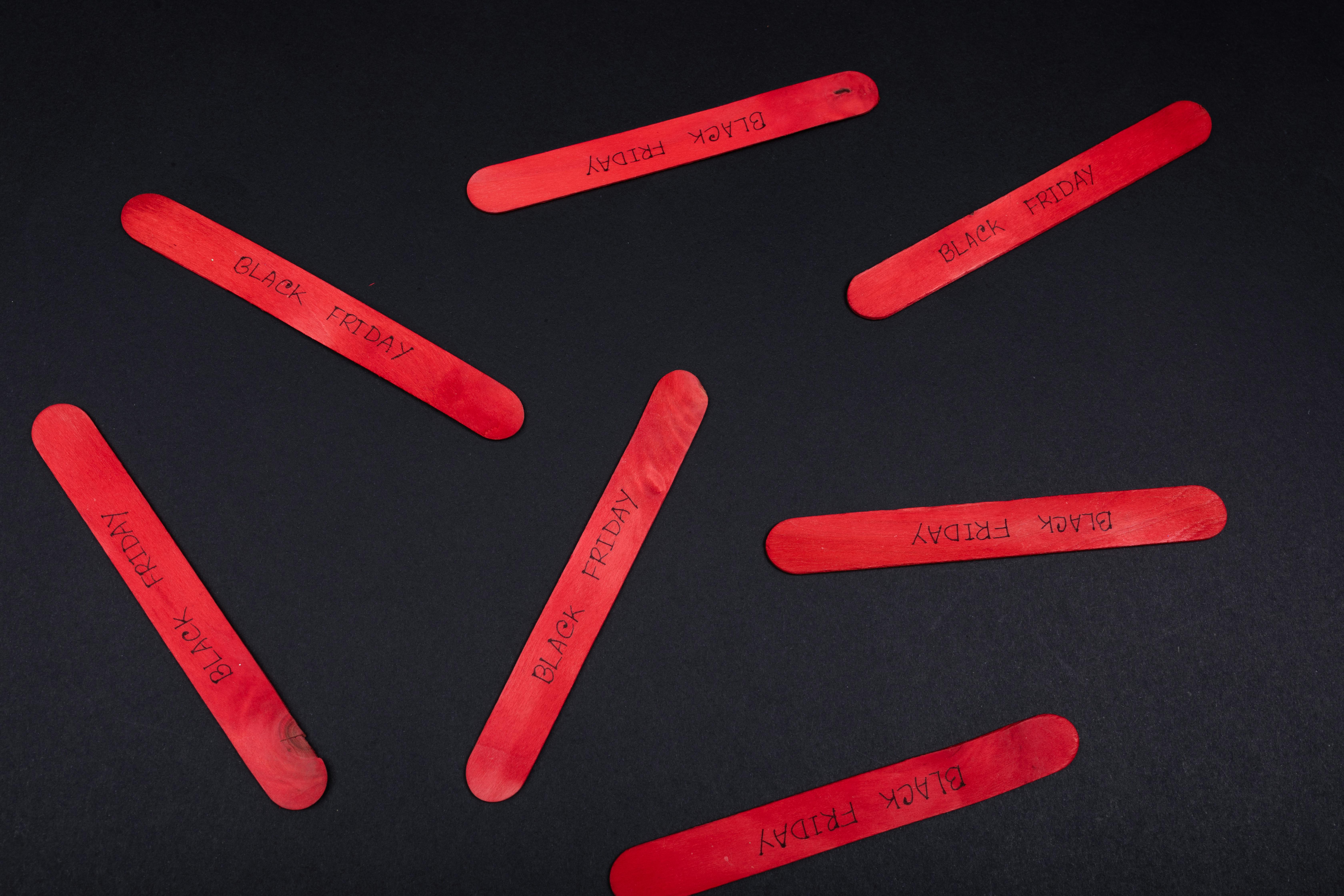 Red Popsicle Sticks on Black Table · Free Stock Photo