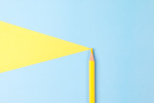A minimalistic composition featuring a yellow pencil forming a triangle on a blue background.