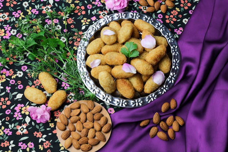 Plate Of Paneer Pakora On Colorful Tablecloth With Almonds And Parsley