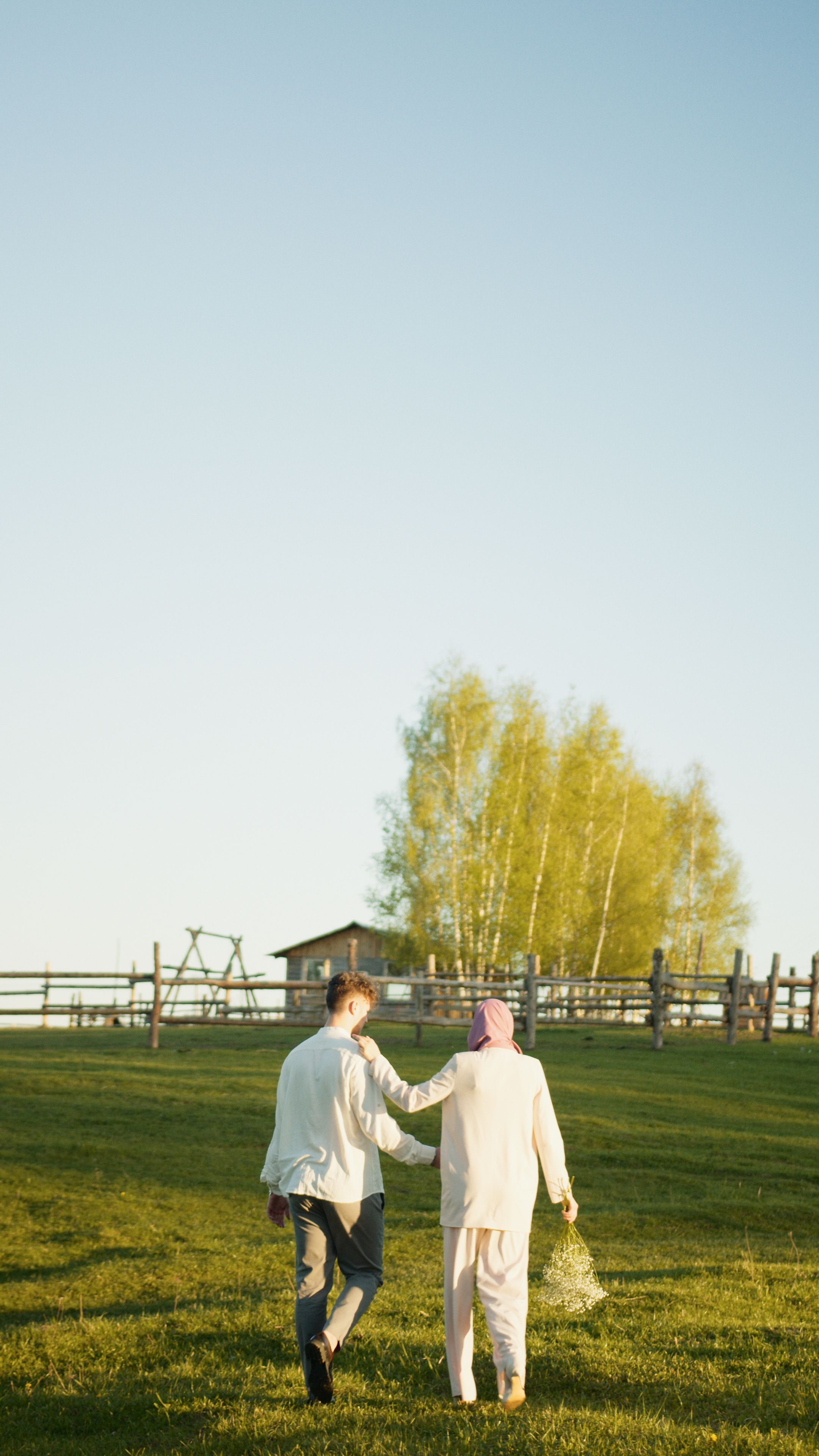 A Couple Walking on a Grassland · Free Stock Photo