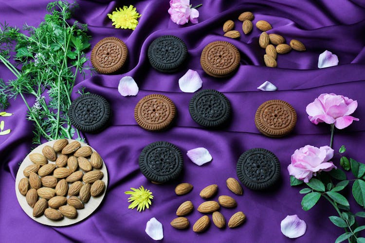 Cookies And Almond Nuts On A Purple Satin Fabric 