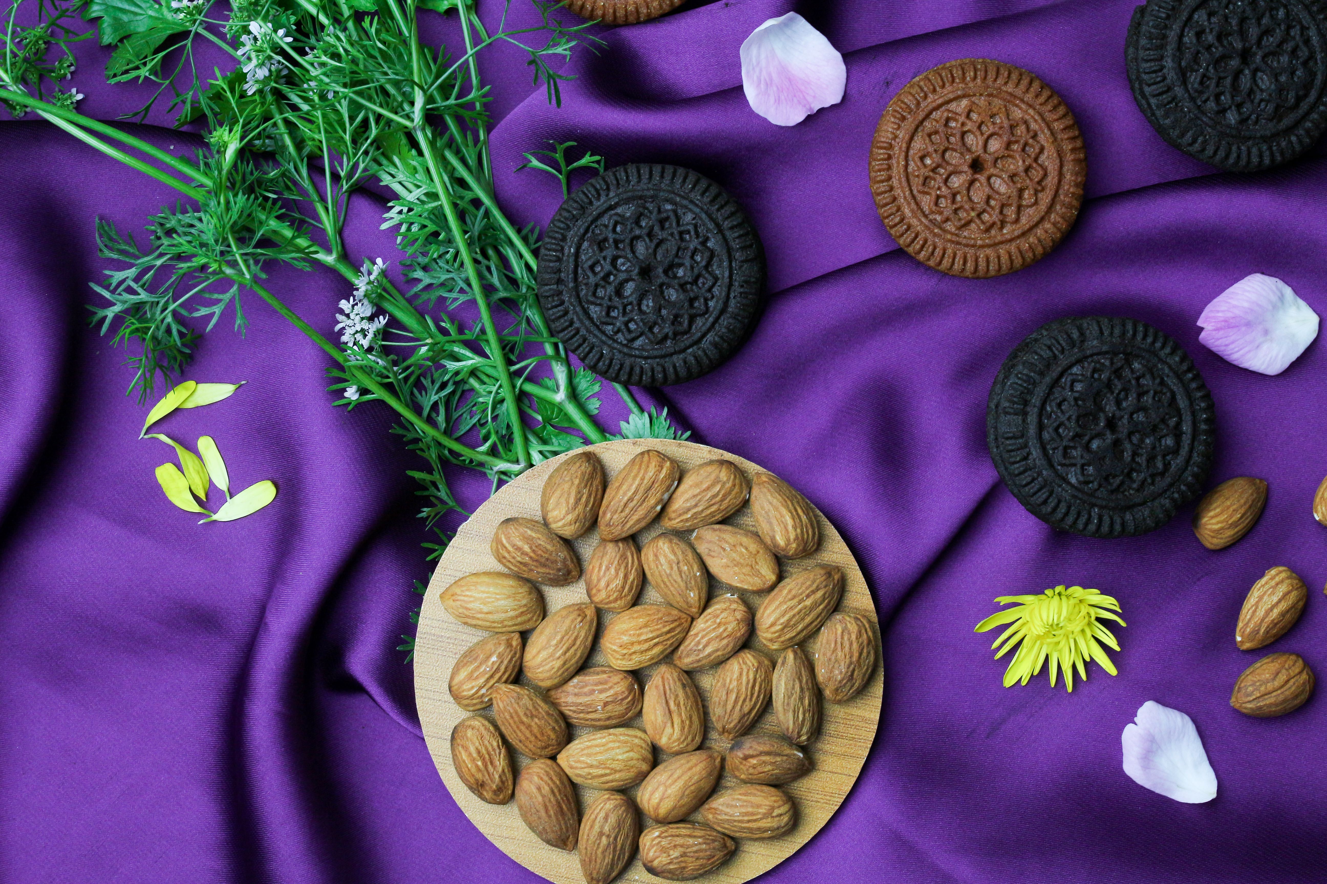 Stack of almond thin biscuits on a rustic wooden table