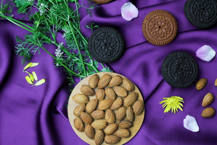 Cookies And Nuts On Purple Fabric Background