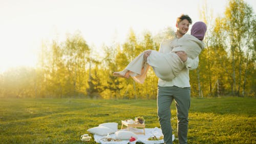 A couple enjoying a romantic picnic outdoors. Smiling and in love.
