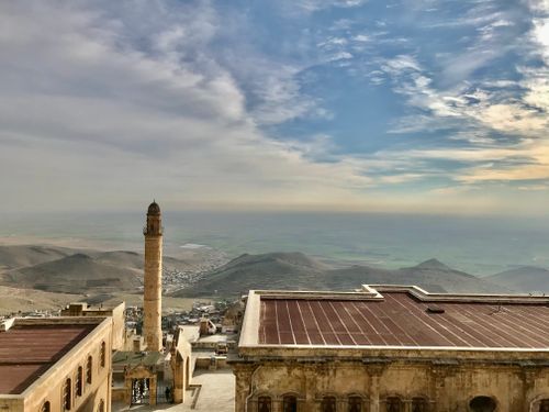 Free Aerial view showcasing a minaret and landscape in Mardin, Turkey. Stock Photo