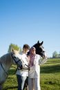 A Couple holding the Horses