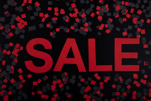 Vibrant sale banner with red text and confetti. Perfect for marketing promotions.