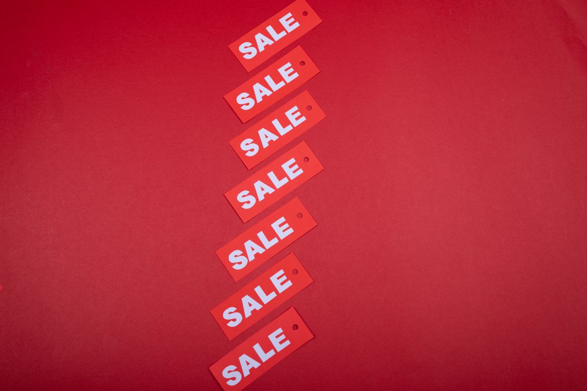 Red sale tags on a red background