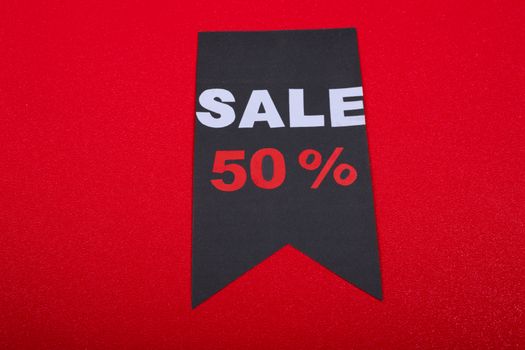 Modern sale tag offering 50% discount on vibrant red background. - Fotografer Sidoarjo