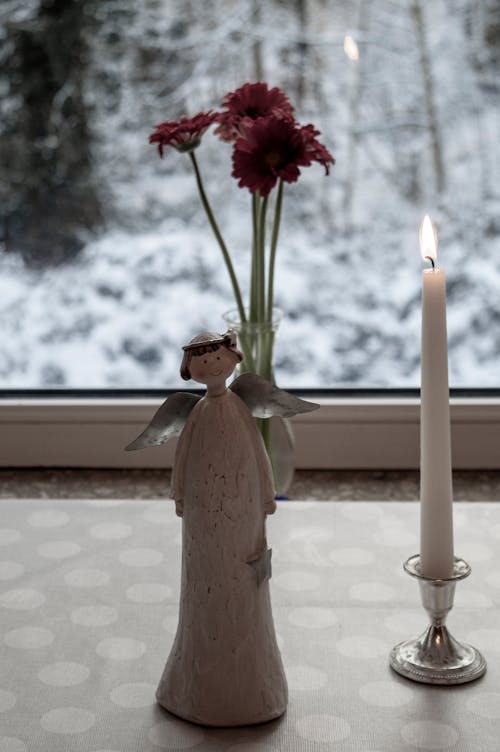Free Flower Vase and Lighted Candle Near the Window Stock Photo