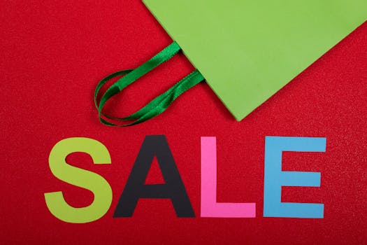Vibrant sale text with green paper bag on a red background, perfect for promotions.