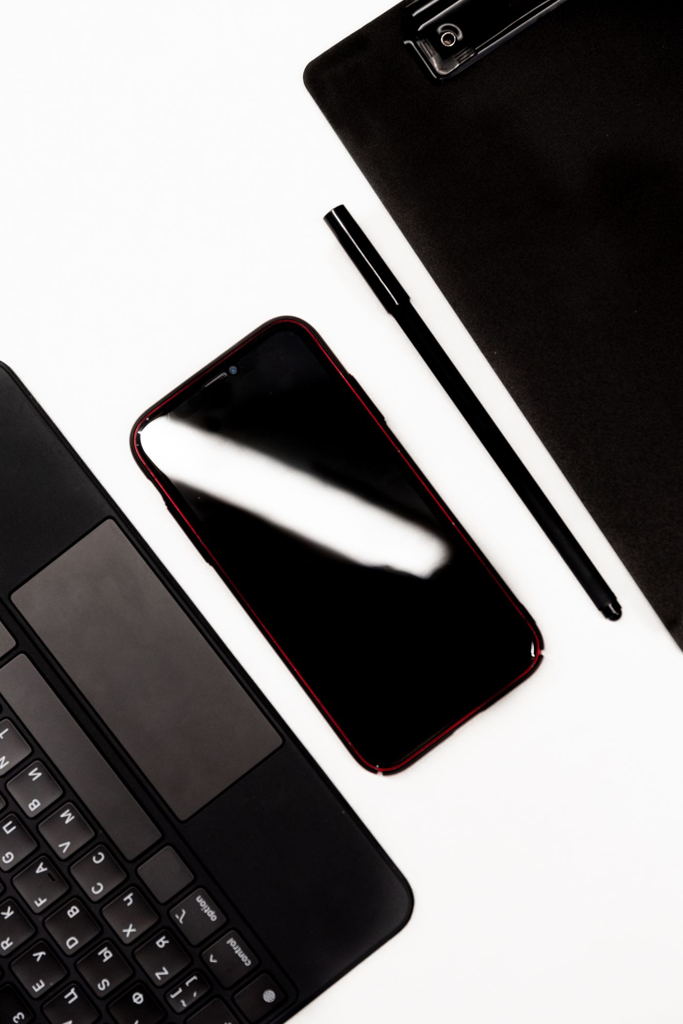 Smartphone and laptop on a desk used for setting up business email on a phone