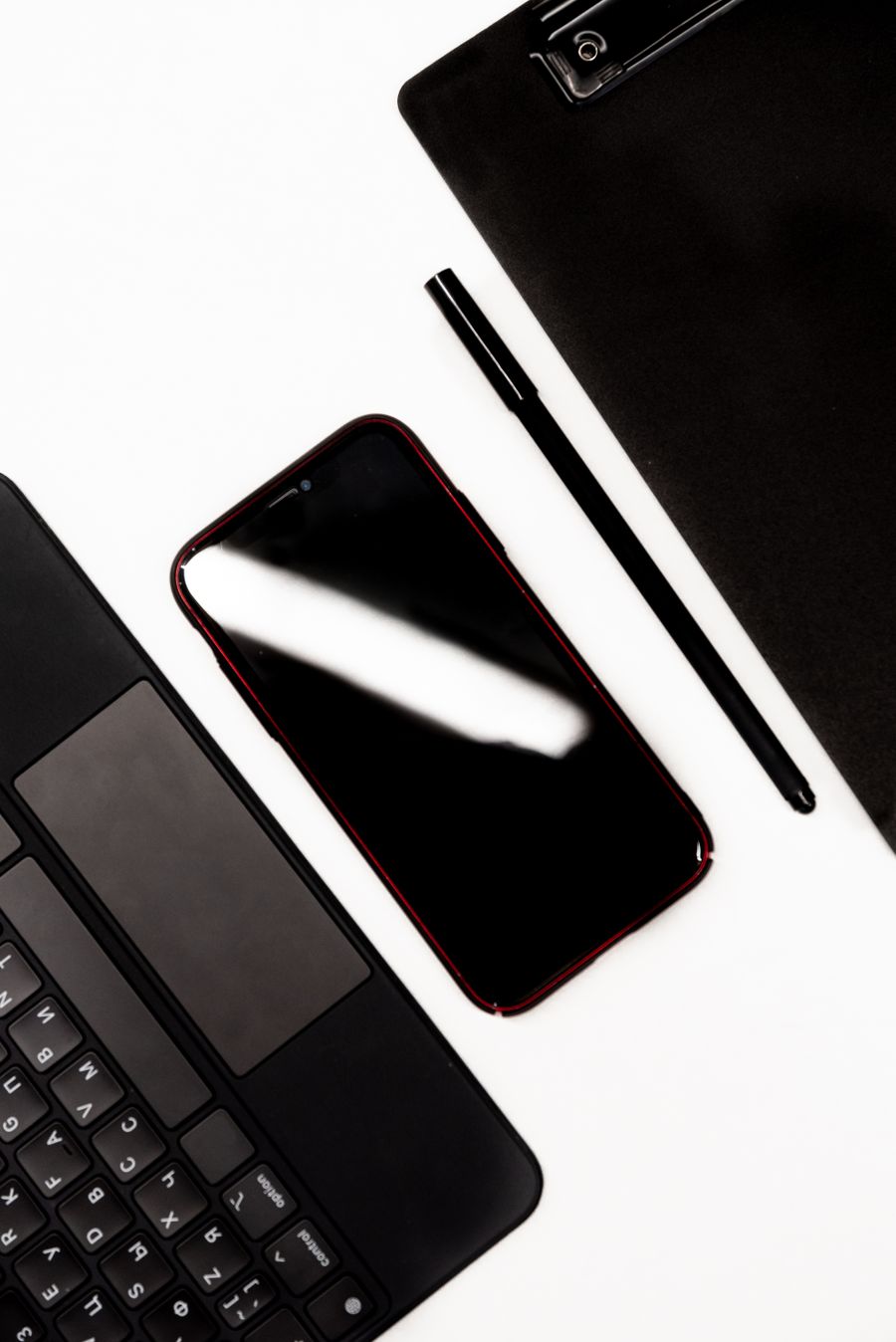 Smartphone and laptop on a desk used for setting up business email on a phone