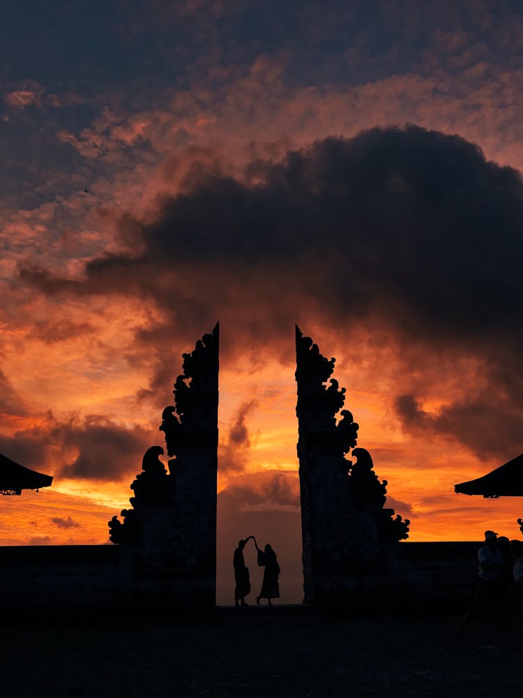 People Standing On Pura Lempuyang Luhur Under Orange Sky